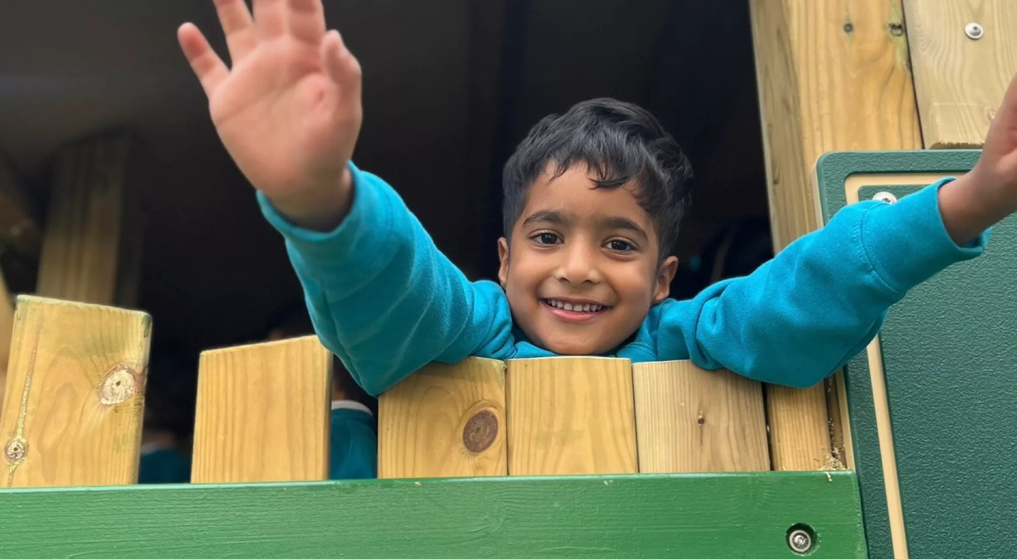 A pupil at Canary Wharf Primary East Ferry enjoying outdoor play in the school's timber adventure playground.