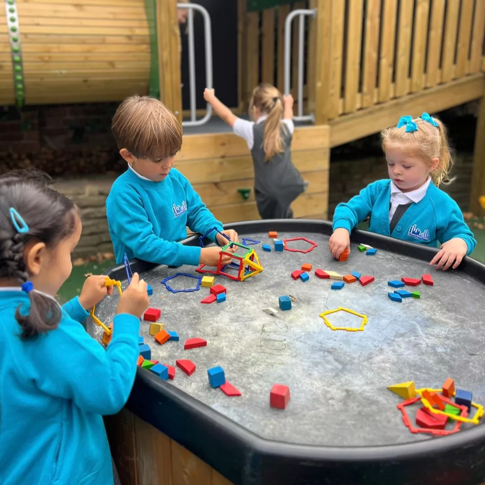 Nursery pupils at Canary Wharf Primary East Ferry developing early maths and problem-solving skills through outdoor play.