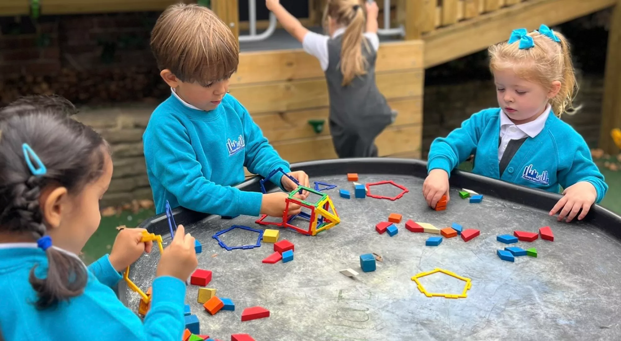 Nursery pupils at Canary Wharf Primary East Ferry developing early maths and problem-solving skills through outdoor play.